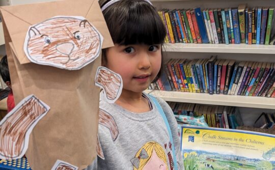 otter puppet with girl